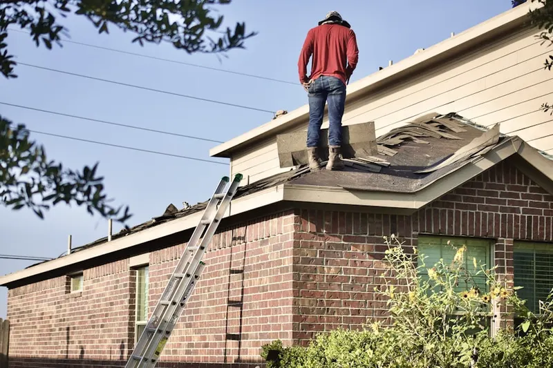 Professional roofer working on a residential roof in Helixville